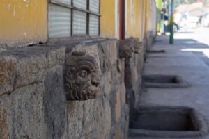 An image of imitation tenon heads adorning the wall of a house in Chavin