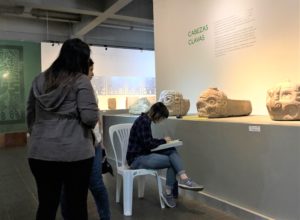 An image of Carly Rose Lacoste drawing a tenon head in the gallery of the national museum