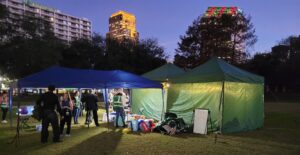 Tulane Street Health tents lit up at night. 