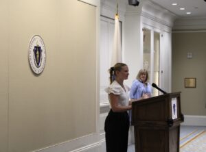 Kaitlyn Crowley introduces Senate President Spilka at a speaker event